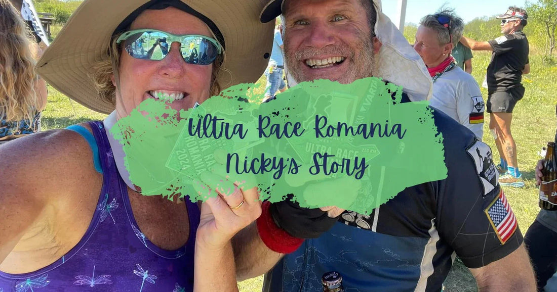 Two smiling ultramarathon runners in outdoor setting holding race medals, wearing sun hats and sunglasses