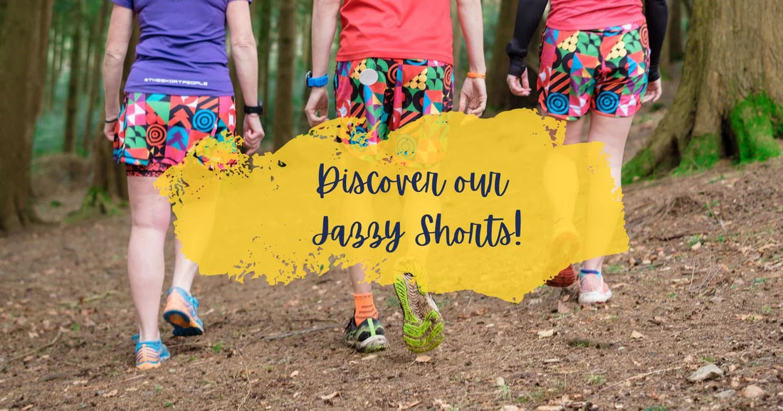 Three people walking on forest trail wearing colorful patterned jazzy shorts and athletic shoes